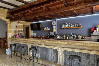 a bar with stools in a room at Casa Palomin
