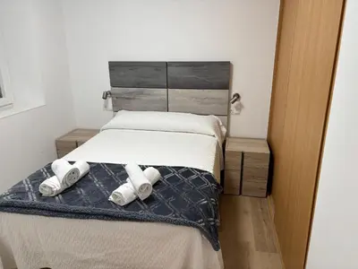 a bedroom with a bed with two pillows on it at Casa do práctico in Foz