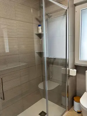 a shower with a glass door in a bathroom at Casa do práctico in Foz