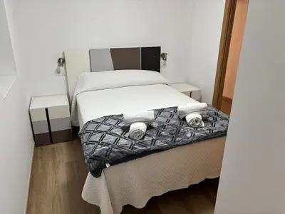 a bedroom with a bed with two night stands at Casa do práctico in Foz