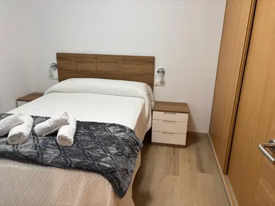 a bedroom with a bed with two towels on it at Casa do práctico in Foz