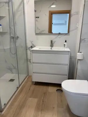 a bathroom with a white sink and a shower at Casa do práctico in Foz