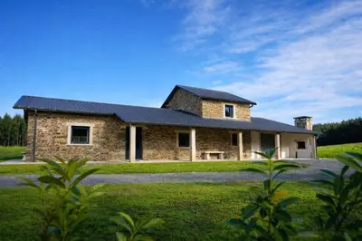 a stone house with a black roof at Casa Rural Lugar Vista Alegre in Lugo