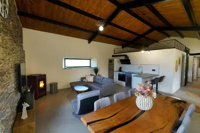 a living room with a wooden table and a couch at Casa Rural Lugar Vista Alegre in Lugo
