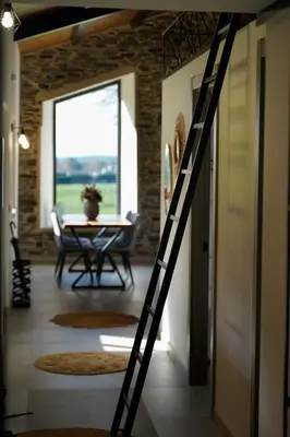 a ladder in a room with a table and a dining room at Casa Rural Lugar Vista Alegre in Lugo