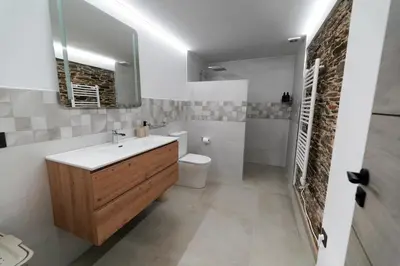 a bathroom with a sink and a toilet and a mirror at Casa Rural Lugar Vista Alegre in Lugo