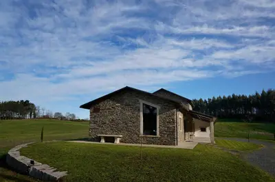 a small stone building on a grassy field at Casa Rural Lugar Vista Alegre in Lugo
