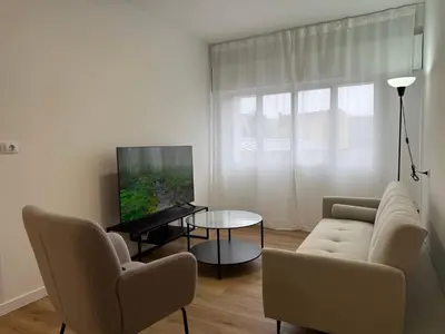 a living room with a couch and chairs and a tv at Apartamento Padrón Centro, A de Marcelino by URent in Padrón