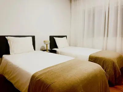 a bed with white sheets and pillows in a bedroom at Apartamento Padrón Centro, A de Marcelino by URent in Padrón