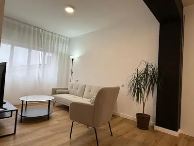 a living room with a couch and a table at Apartamento Padrón Centro, A de Marcelino by URent in Padrón