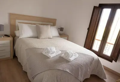 a bedroom with a bed with two towels on it at Casa Aradas in Santiago de Compostela