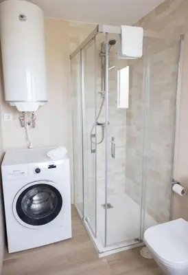 a bathroom with a washing machine and a shower at Casa Aradas in Santiago de Compostela