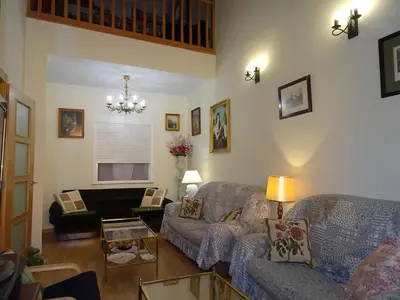 a living room with a couch and a table at A CASONA DO BARCO con garaje privado, jardín y buenas vistas in O Barco de Valdeorras