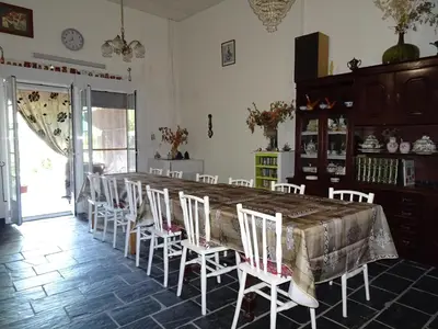 a dining room with a large table and chairs at A CASONA DO BARCO con garaje privado, jardín y buenas vistas in O Barco de Valdeorras