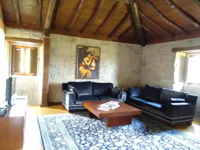 a living room with black leather couches and a table at Holiday Home mit Privatpool by Interhome in Parada del Sil