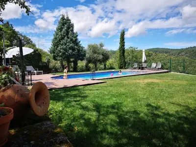 a swimming pool in a yard with a child in the grass at Holiday Home mit Privatpool by Interhome in Parada del Sil