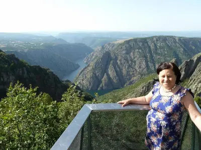 a woman standing on the ledge of a mountain at Holiday Home mit Privatpool by Interhome in Parada del Sil