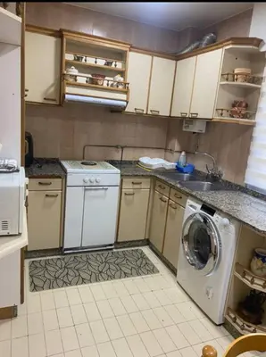 a kitchen with a washing machine and a sink at Barreiros in Barreiros