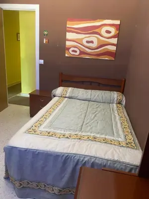 a bedroom with a bed and a painting on the wall at Barreiros in Barreiros