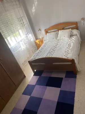 a bedroom with a bed and a checkered floor at Barreiros in Barreiros