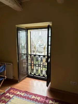 an open door to a balcony with a gate at Casa de la fuente de Vista Alegre in Sarria