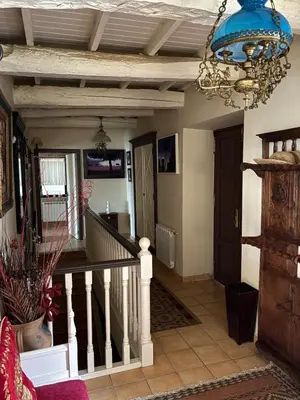 a living room with a staircase and a chandelier at Casa de la fuente de Vista Alegre in Sarria