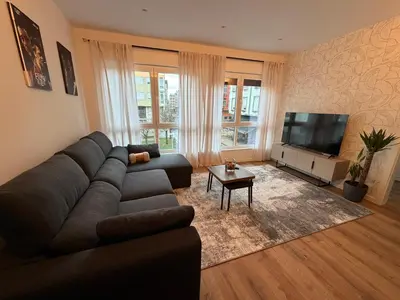 a living room with a couch and a flat screen tv at Milagrosa Square in Lugo