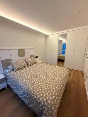 a bedroom with a large bed in a room at Milagrosa Square in Lugo