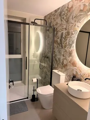 a bathroom with a toilet and a shower and a sink at Milagrosa Square in Lugo