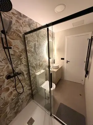 a bathroom with a shower with a toilet and a sink at Milagrosa Square in Lugo