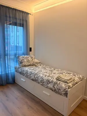 a bed in a room with a window at Milagrosa Square in Lugo