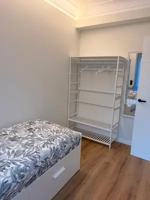 a bedroom with a bed and a closet at Milagrosa Square in Lugo