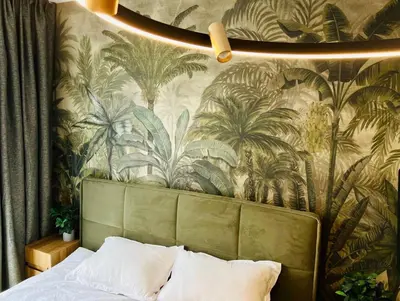 a bedroom with a wall mural of palm trees at Apartamento Moderno en el Centro !-CheckHostProfile-! in Lugo