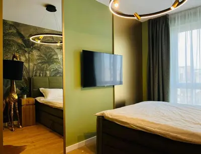 a bedroom with a bed and a flat screen tv on the wall at Apartamento Moderno en el Centro !-CheckHostProfile-! in Lugo