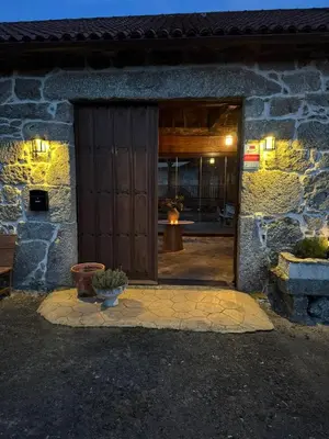 an entrance to a stone building with a wooden door at Cima de Vila in Taboada