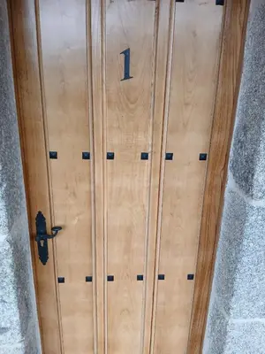 a wooden door with the number on it at Cima de Vila in Taboada