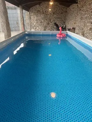 a swimming pool with a pink float in the water at Cima de Vila in Taboada