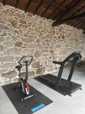 a bike parked next to a stone wall at Cima de Vila in Taboada