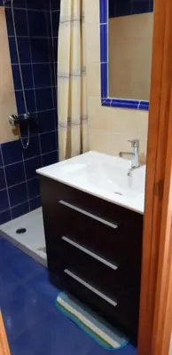 a bathroom with a sink and a mirror at El Pajar de Triana in Brañuelas