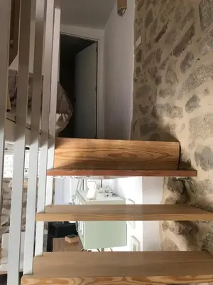 a bathroom with wooden shelves and a mirror at Casa Media Lúa in Allariz