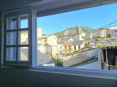 an open window with a view of a city at Apartamento Maruja Mallo in Viveiro