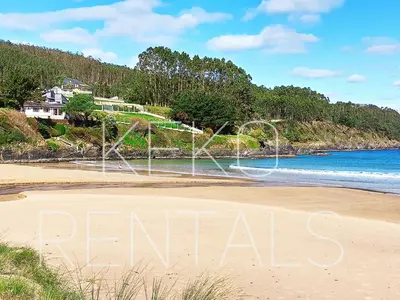 a beach with the word rentals written in the sand at Apartamento Maruja Mallo in Viveiro