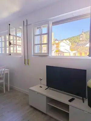 a living room with a large flat screen tv at Apartamento Maruja Mallo in Viveiro