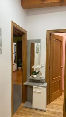 a room with a mirror and a table with flowers on it at Nido 33 in Ribadeo