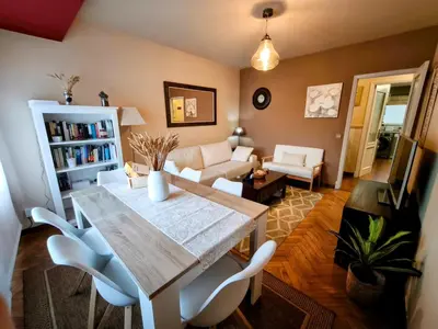 a living room with a table and chairs and a couch at piso céntrico y muy luminoso 1C in Santiago de Compostela