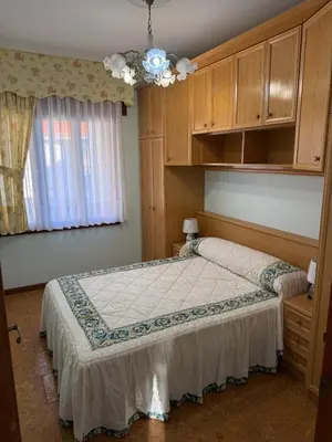 a bedroom with a bed and a ceiling fan at Villa Laxes in Burela de Cabo