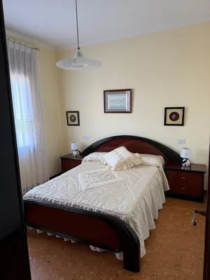 a bedroom with a bed with a wooden head board at Villa Laxes in Burela de Cabo
