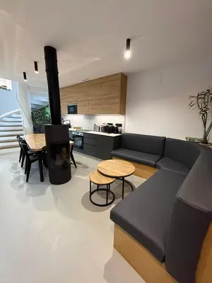 a living room with a couch and a table and a stove at Adiva A Zapataría in Puentedeume