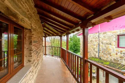 a balcony of a house with a stone wall at Casa Ruperto in Doade