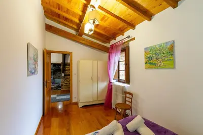 a bedroom with a bed and a wooden ceiling at Casa Ruperto in Doade